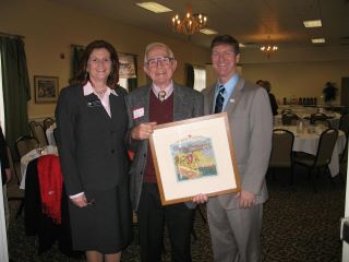 John Andrews holding his award artwork